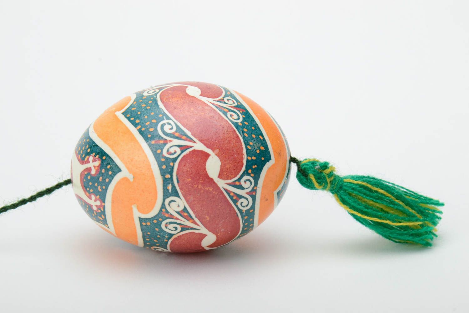 Handmade decorative colorful painted Easter egg pysanka with green tassel photo 3