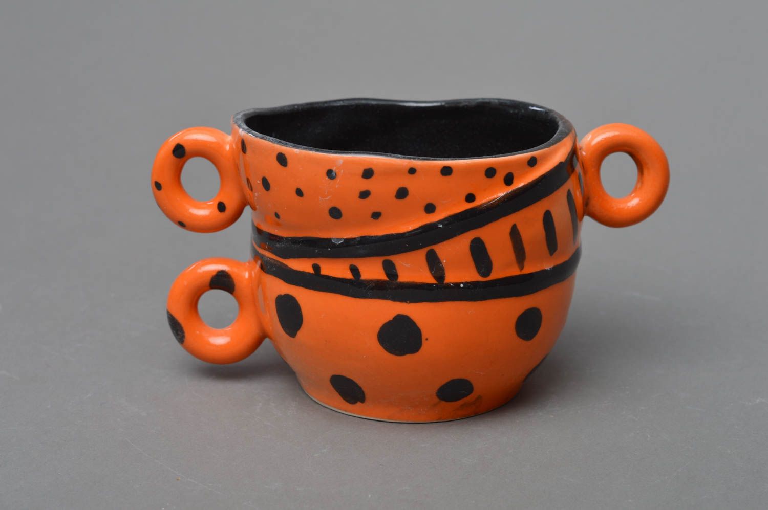 Clay orange and black glazed coffee cup with three handles and black glaze inside photo 1