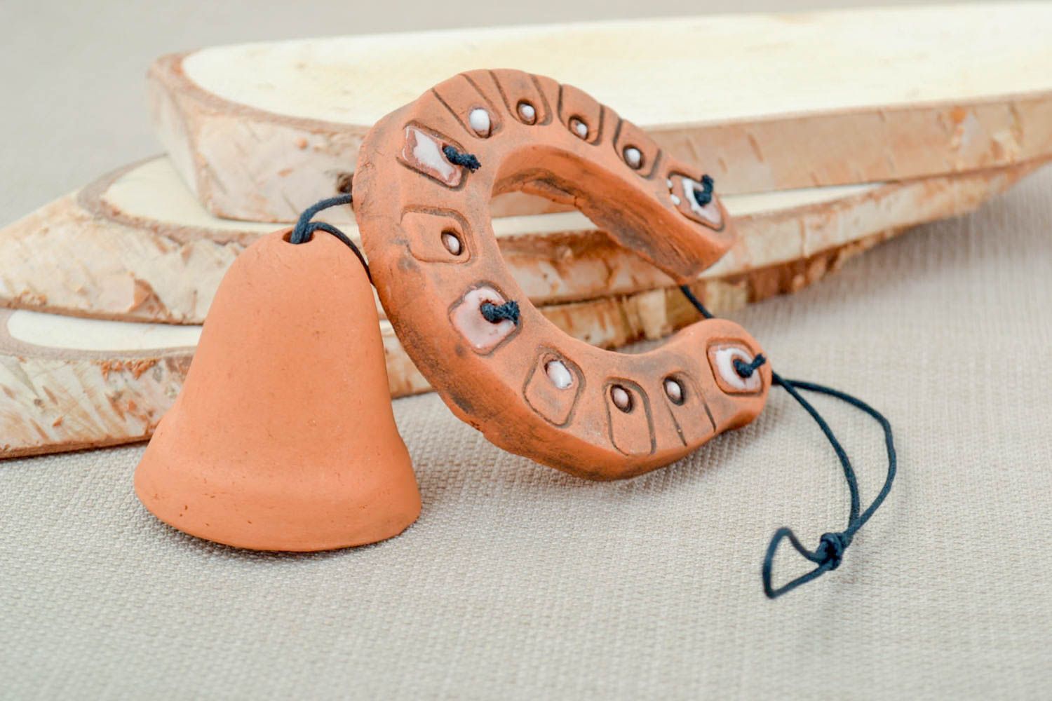 Handmade ceramic set of horseshoe and bell stylish clay interior decorations photo 1