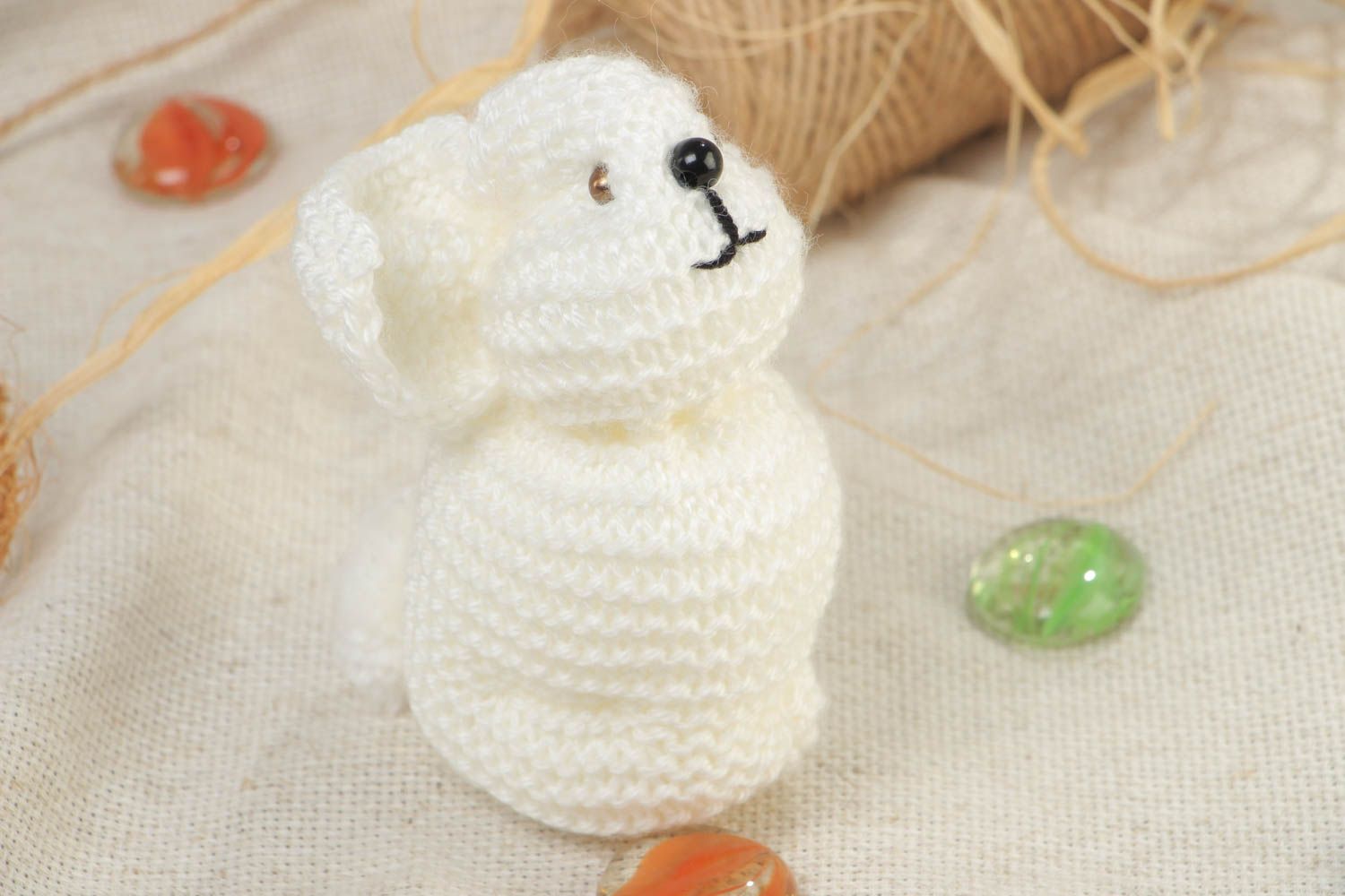 Handmade small soft toy knitted of white acrylic threads in the shape of rabbit photo 1