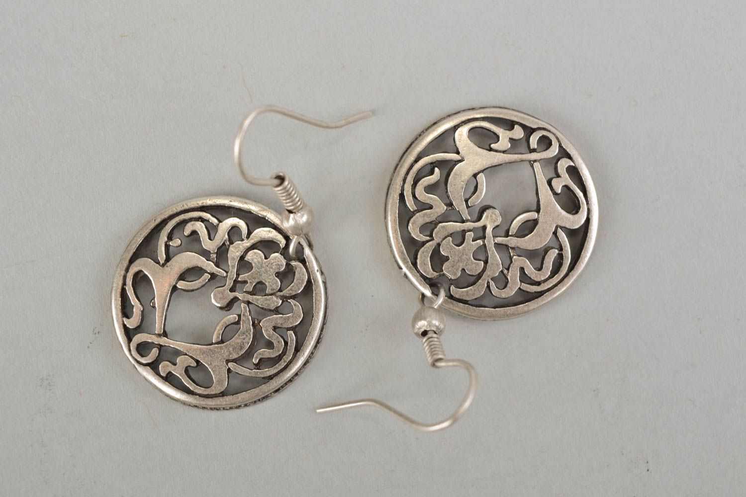 Round metal earrings with curls photo 3