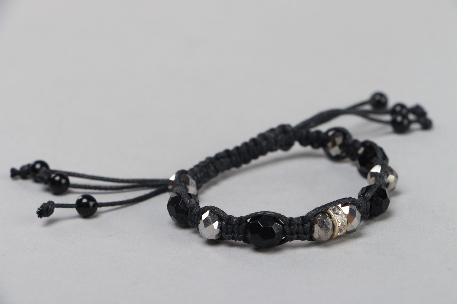 Handmade wrist bracelet woven of waxed cord with glass beads in dark color palette photo 2
