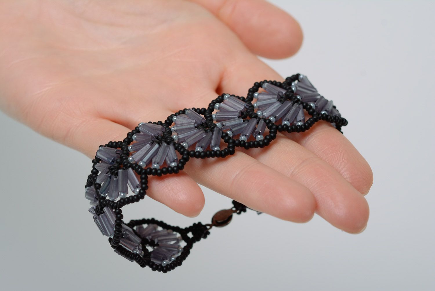 Handmade evening lacy wrist bracelet woven of beads in dark color palette  photo 1