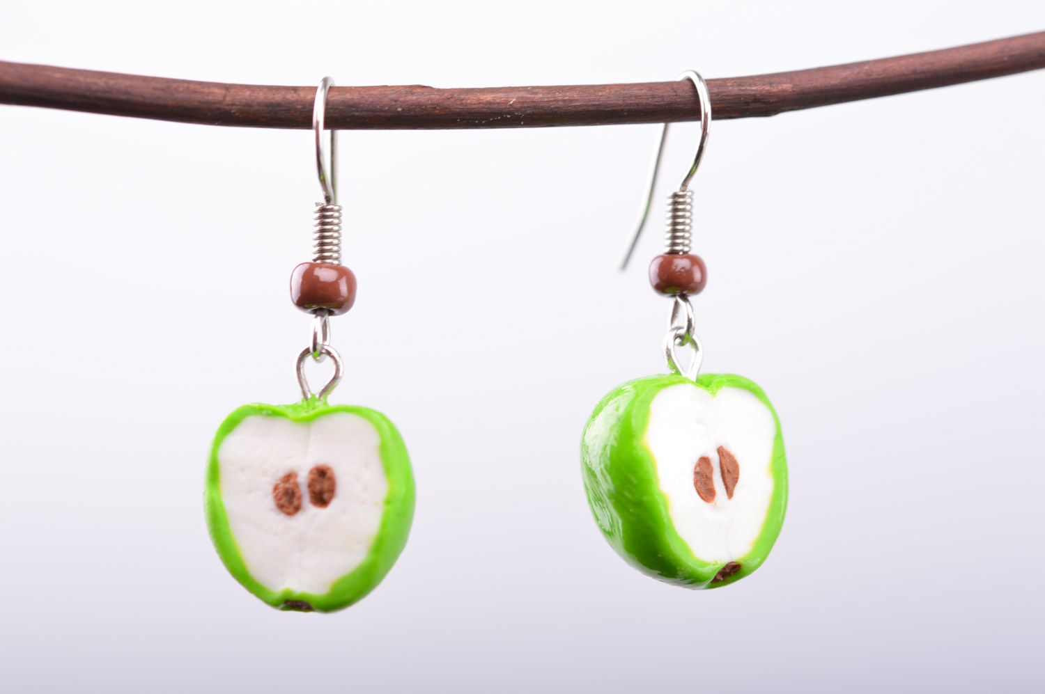 Bright lime and white handmade polymer clay earrings with charms in the shape of apple halves photo 2