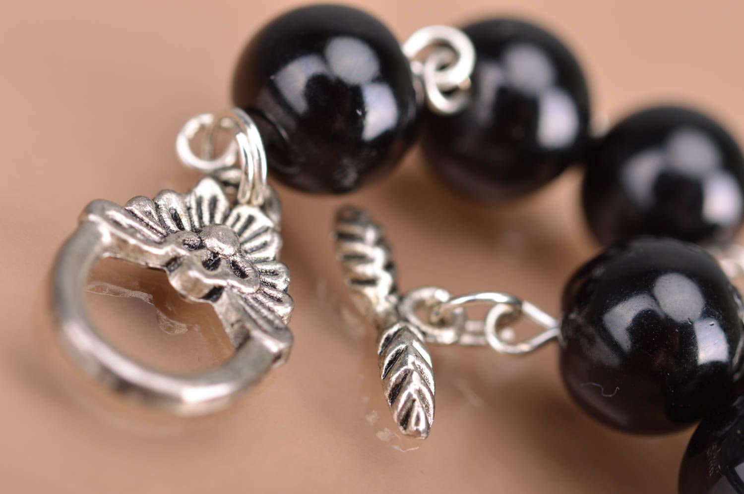 Designer women's wrist handmade bracelet with metal elements and black beads photo 4