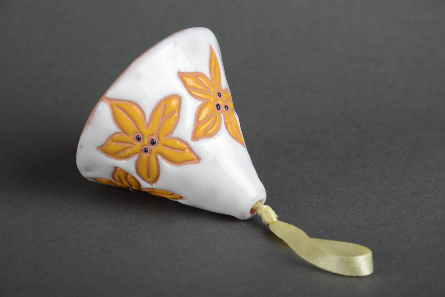 Handmade decorative ceramic bell painted with yellow flowers on white background photo 4