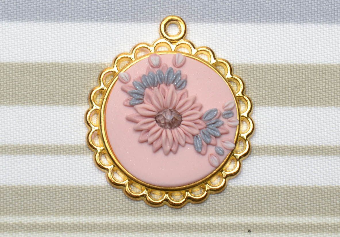 Polymer clay pendant with golden-colored frame photo 1
