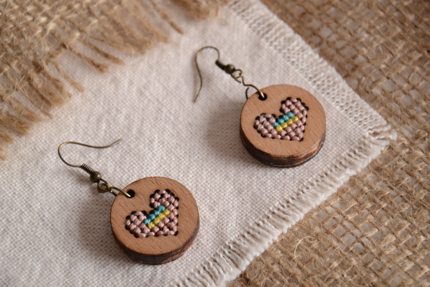 Handmade round plywood earrings with cross-stitch embroidery Pink Hearts photo 1