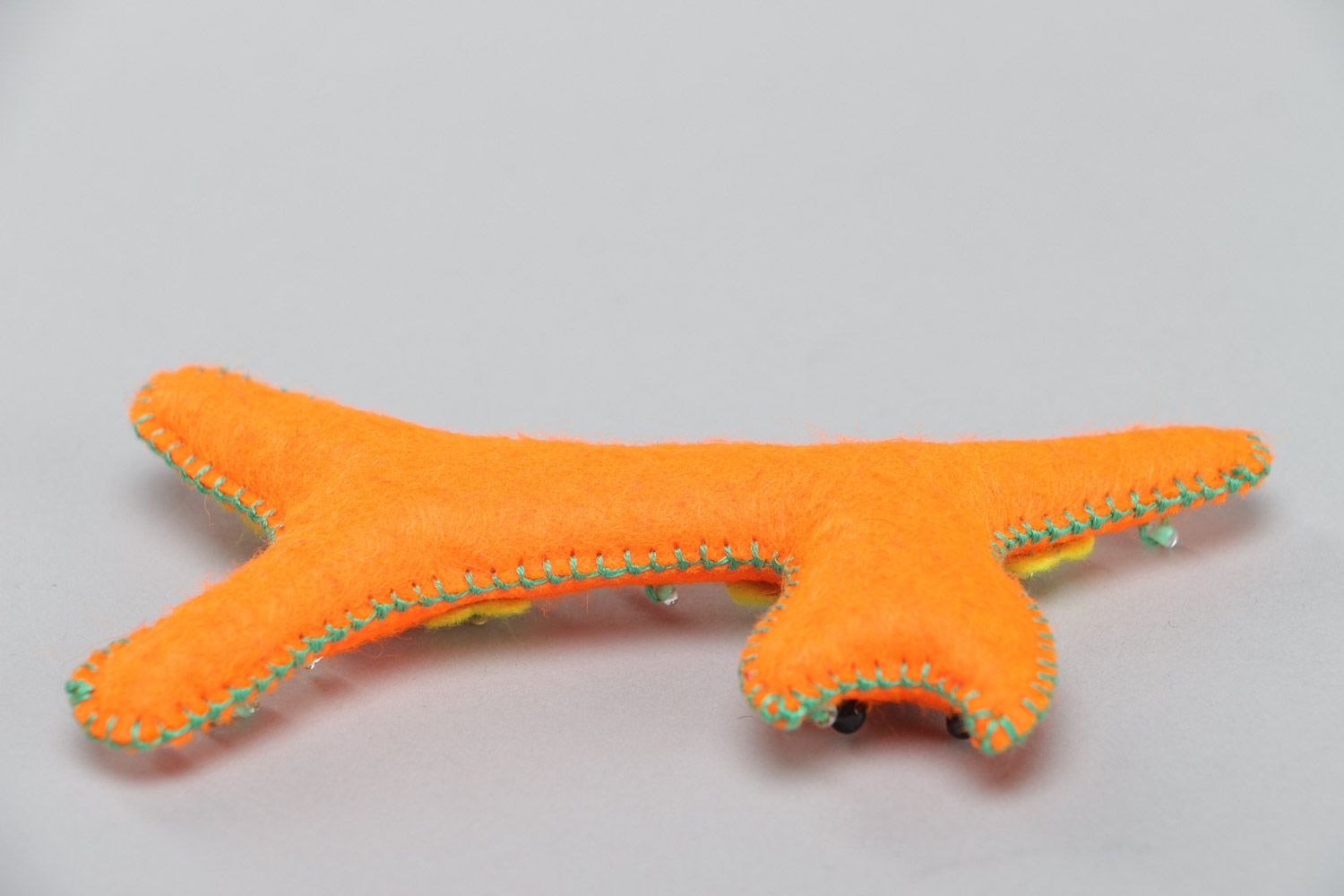 Handmade small soft toy sewn of felt in the shape of long orange kitten  photo 4