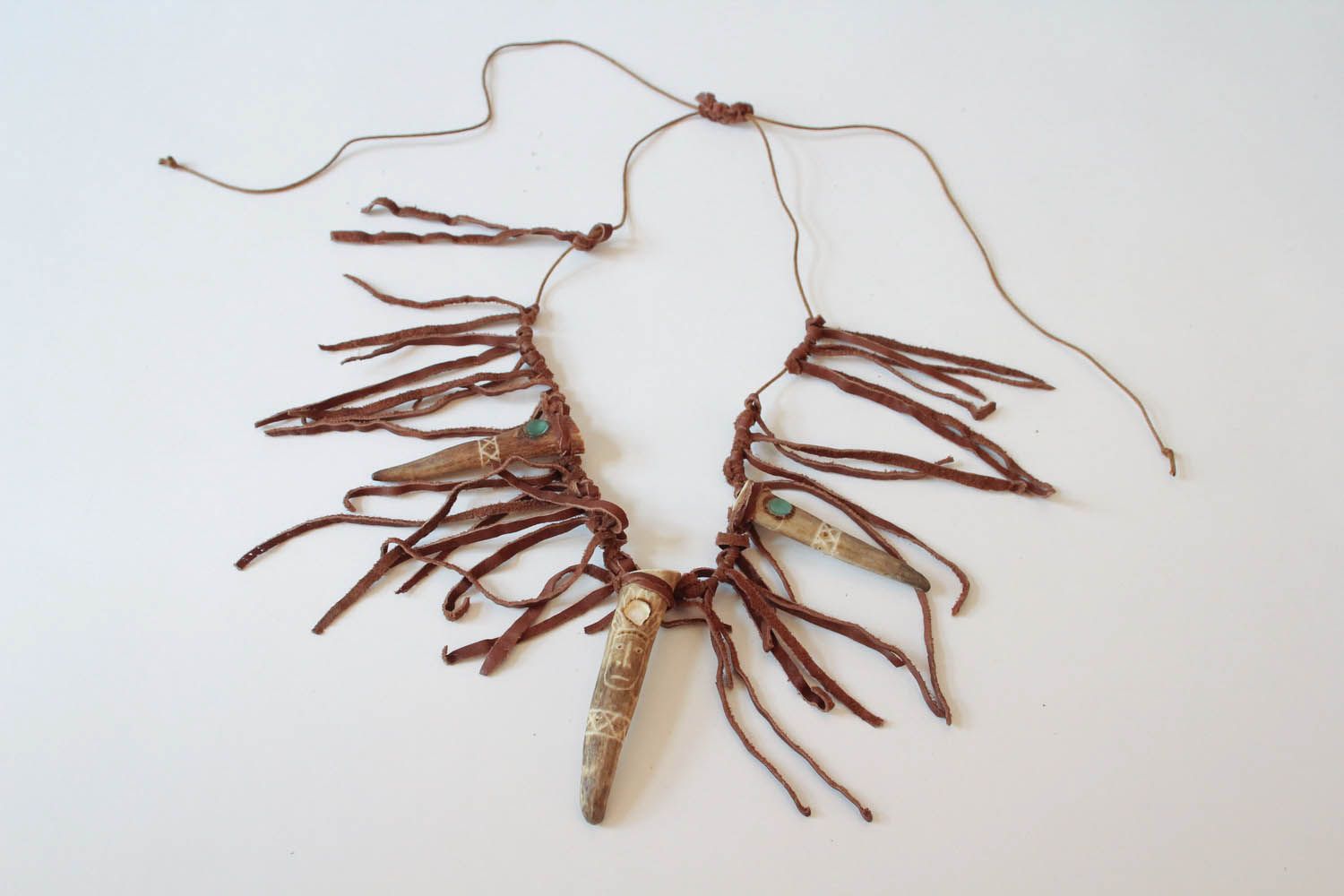 Ethnic pendant made of antler and leather photo 4