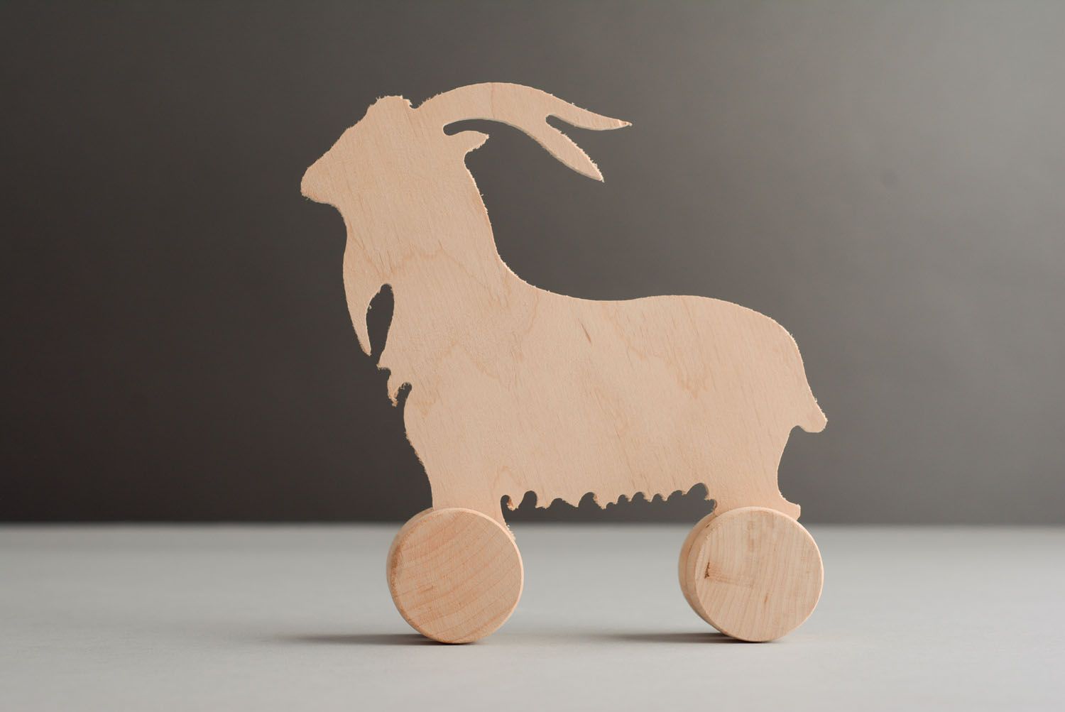 Wooden toy with wheels Goat photo 1