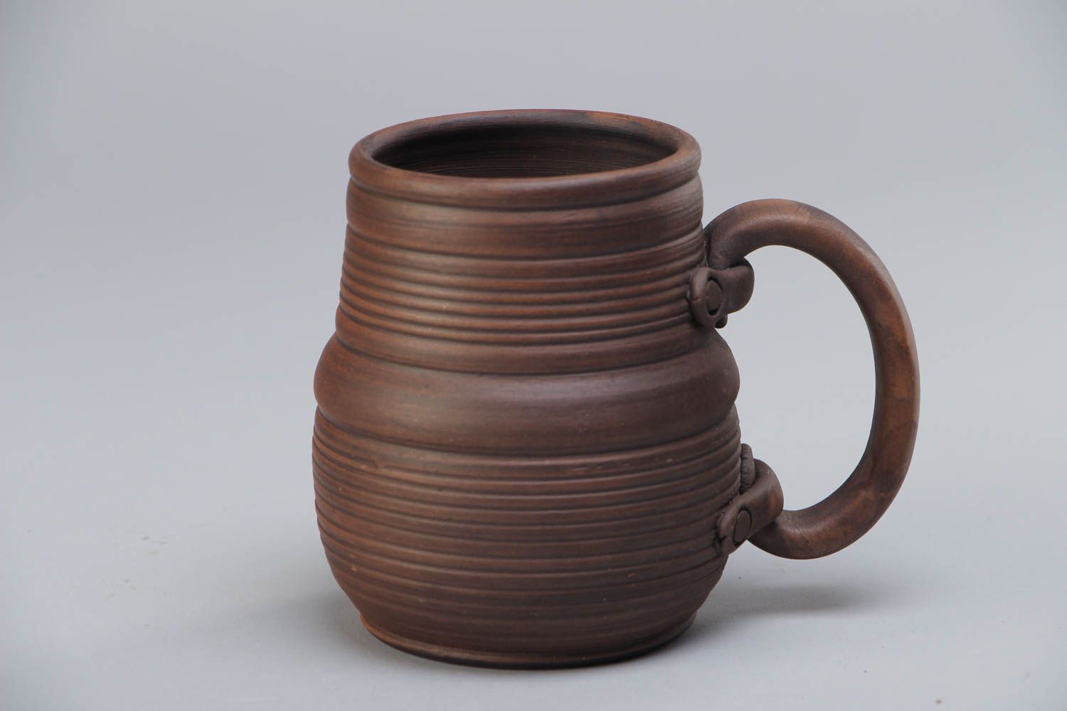Homemade dark brown ceramic beer mug molded of red clay kilned with milk photo 2
