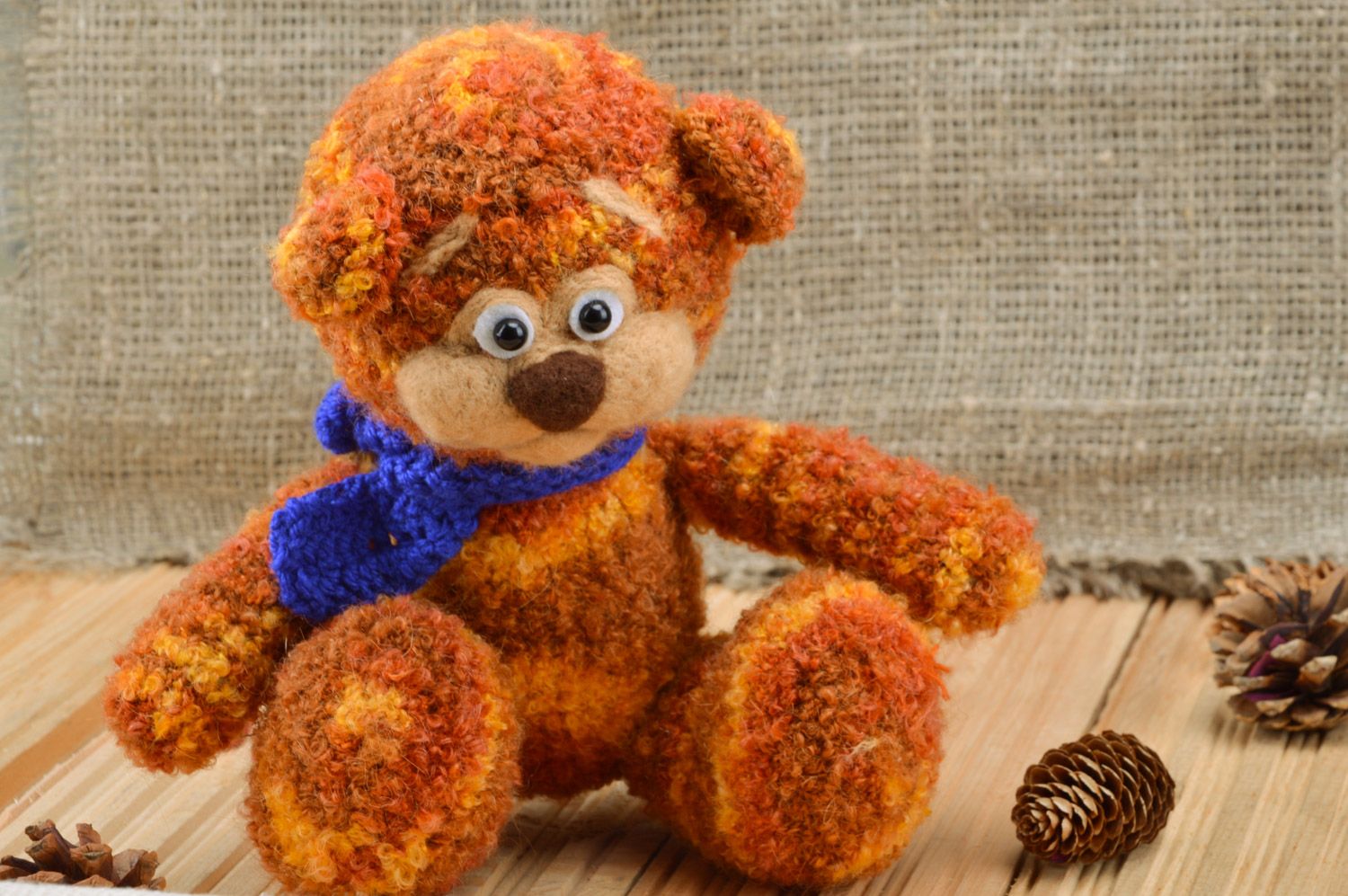 Handmade crochet soft toy in the shape of brown bear with blue scarf for children photo 1