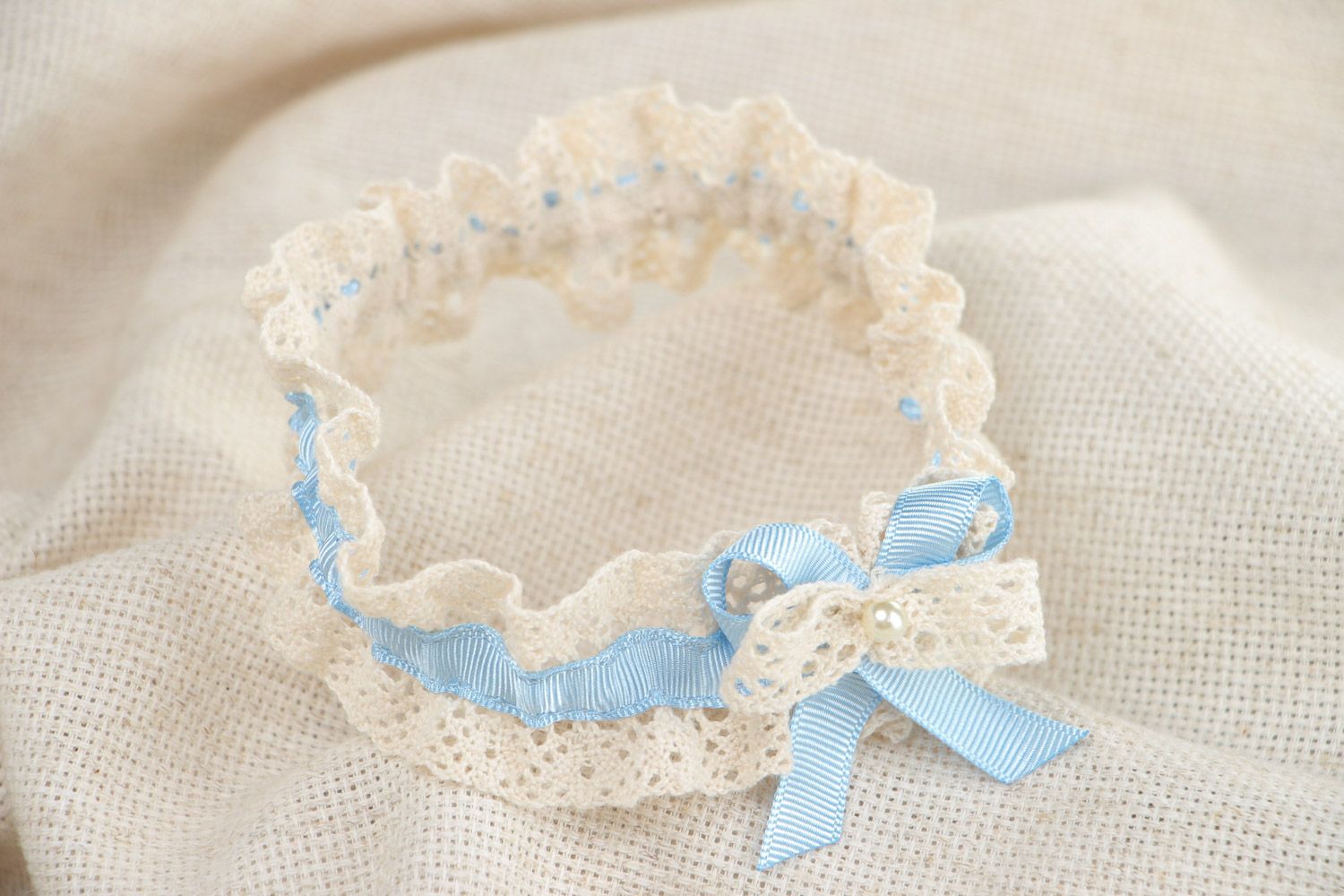 Handmade ivory colored lace bridal garter with tender blue ribbon and pearls photo 1