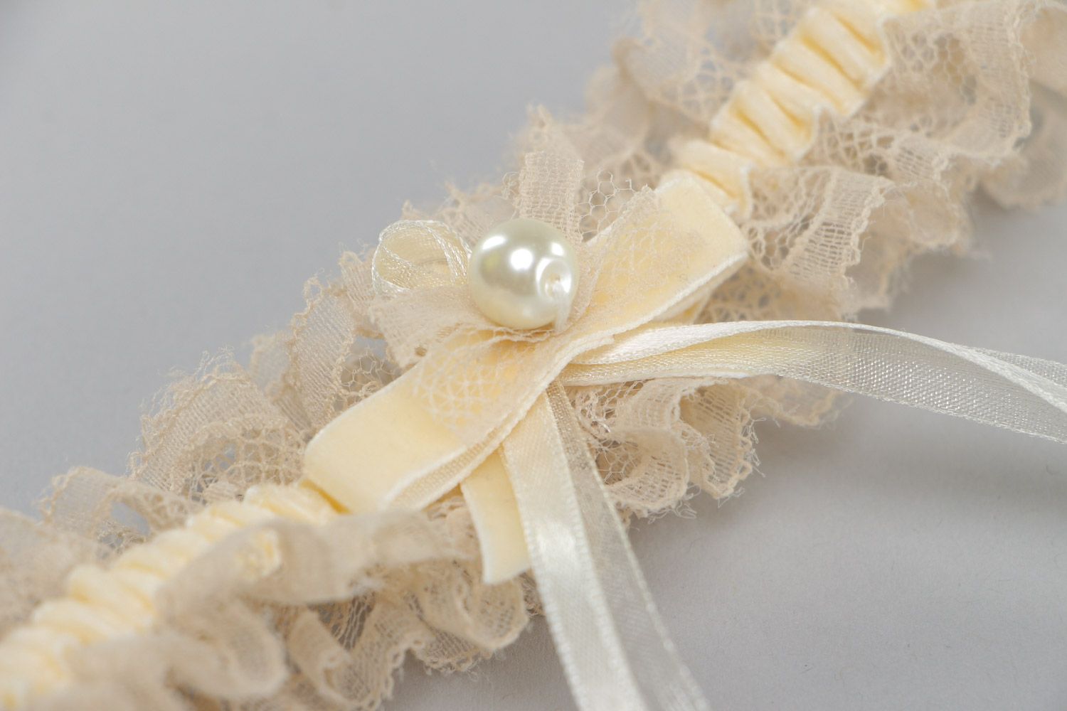 Tender thin lacy wedding bridal garter of champagne color with velor and pearls  photo 3