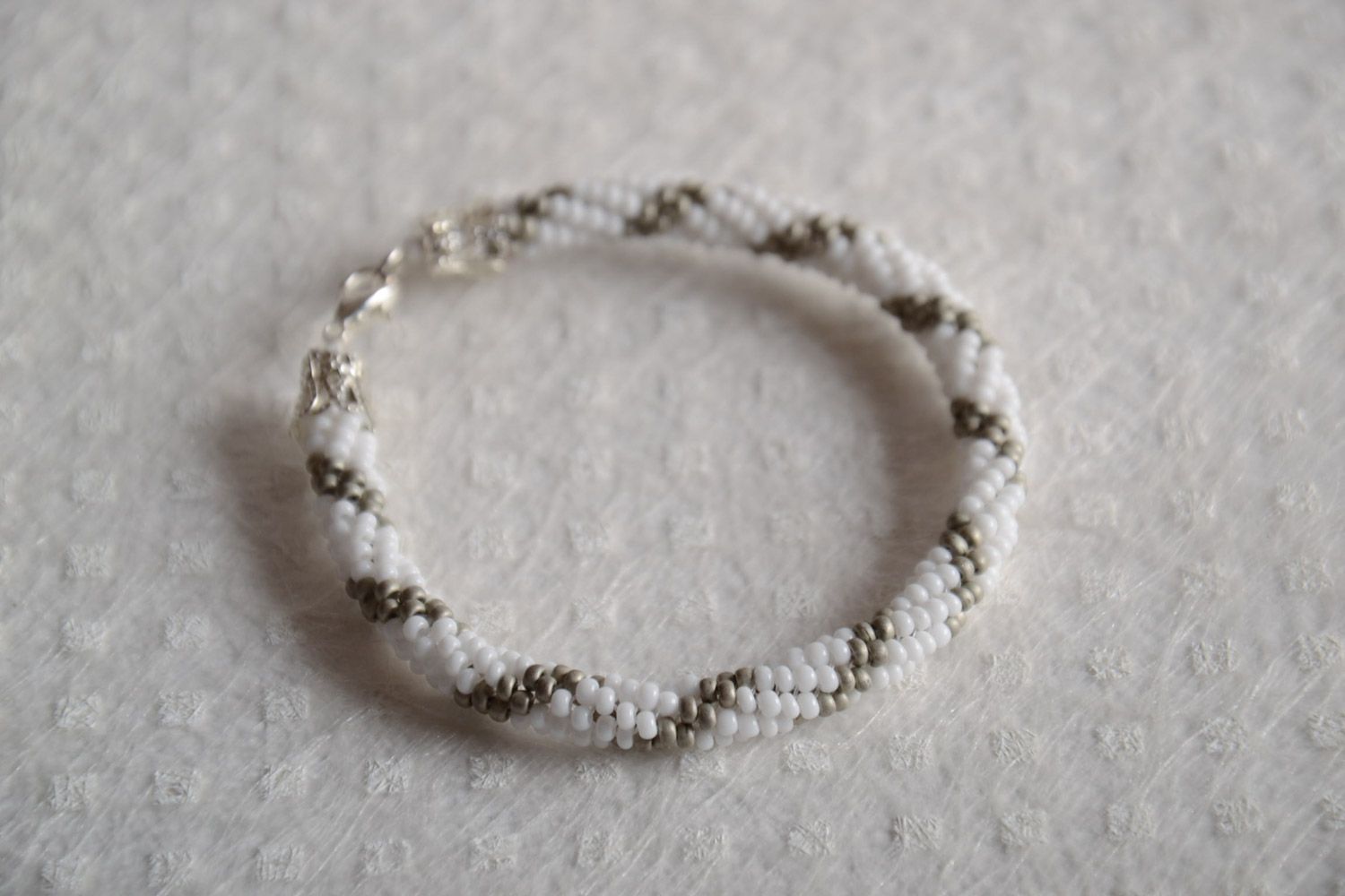 Handmade beaded cord bracelet woven of Czech beads of light color photo 1