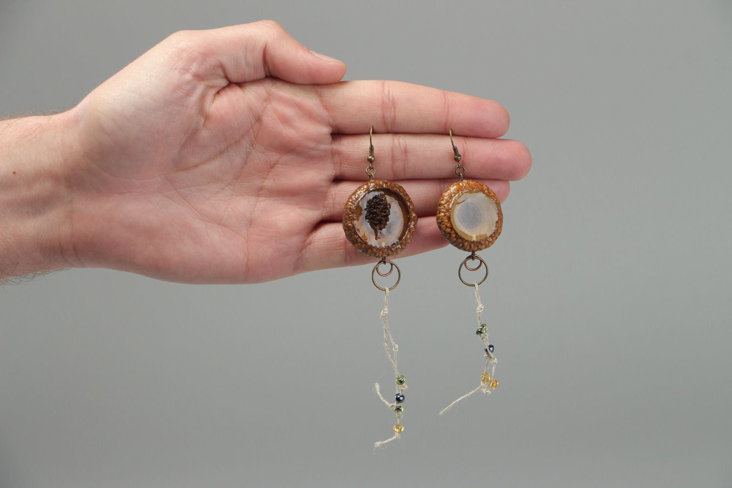 Handmade dangle earrings made of natural materials coated with epoxy resin photo 4