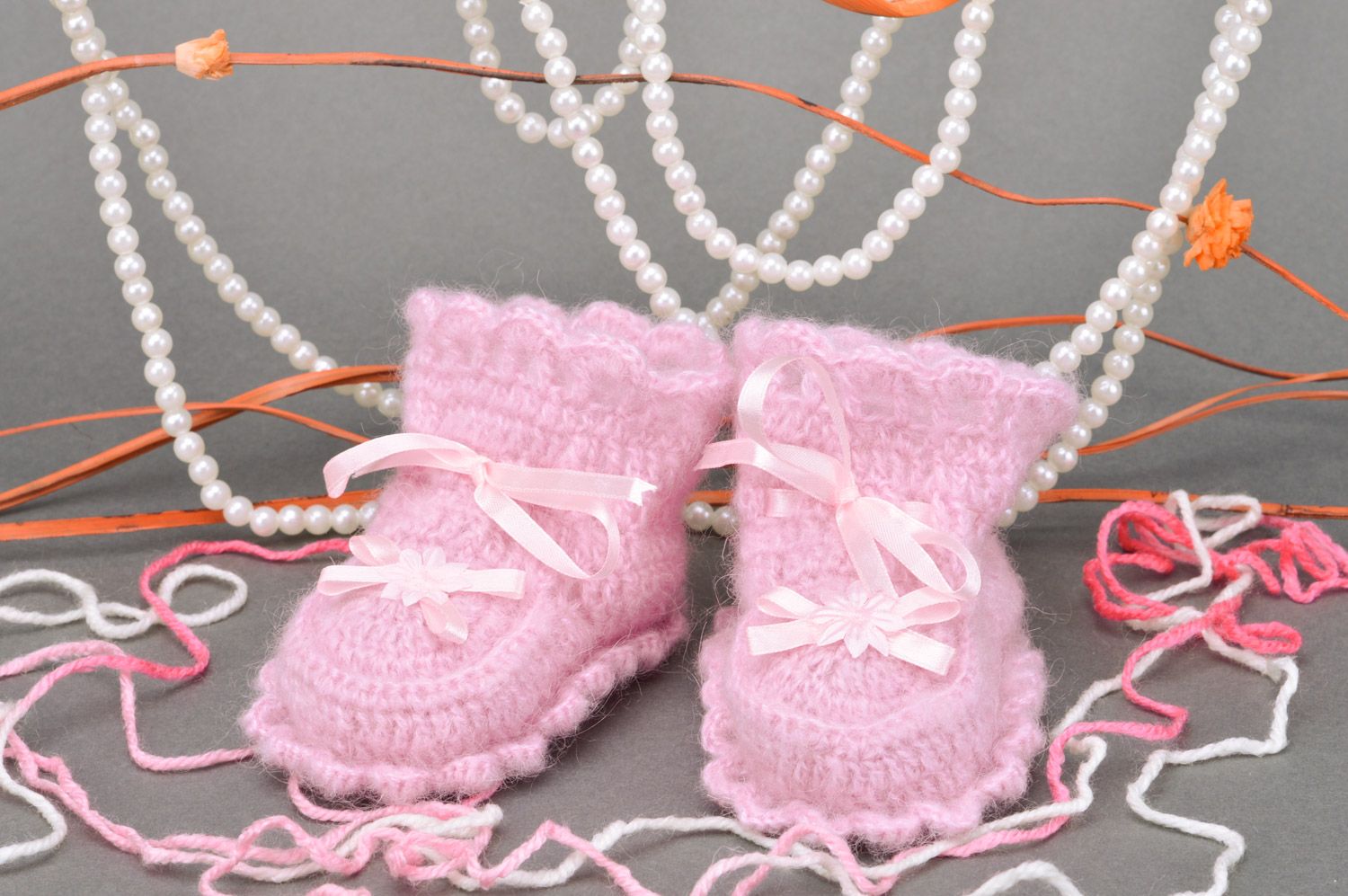 Handmade crocheted baby booties for girls made of angora in pink color with bows photo 1