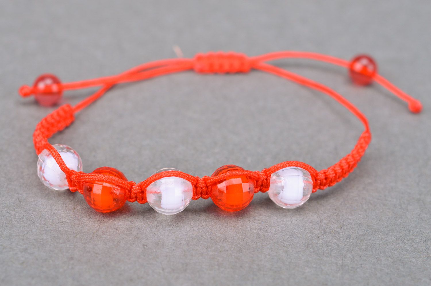 Beautiful bright handmade children's bracelet woven of threads and beads photo 5