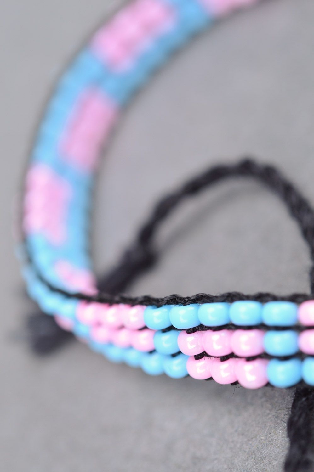 Thin handmade wrist bracelet woven of pink and blue beads with ties for women photo 4