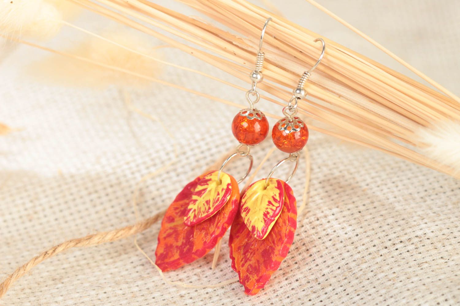 Handmade polymer clay dangling earrings with bright orange leaves with beads photo 1