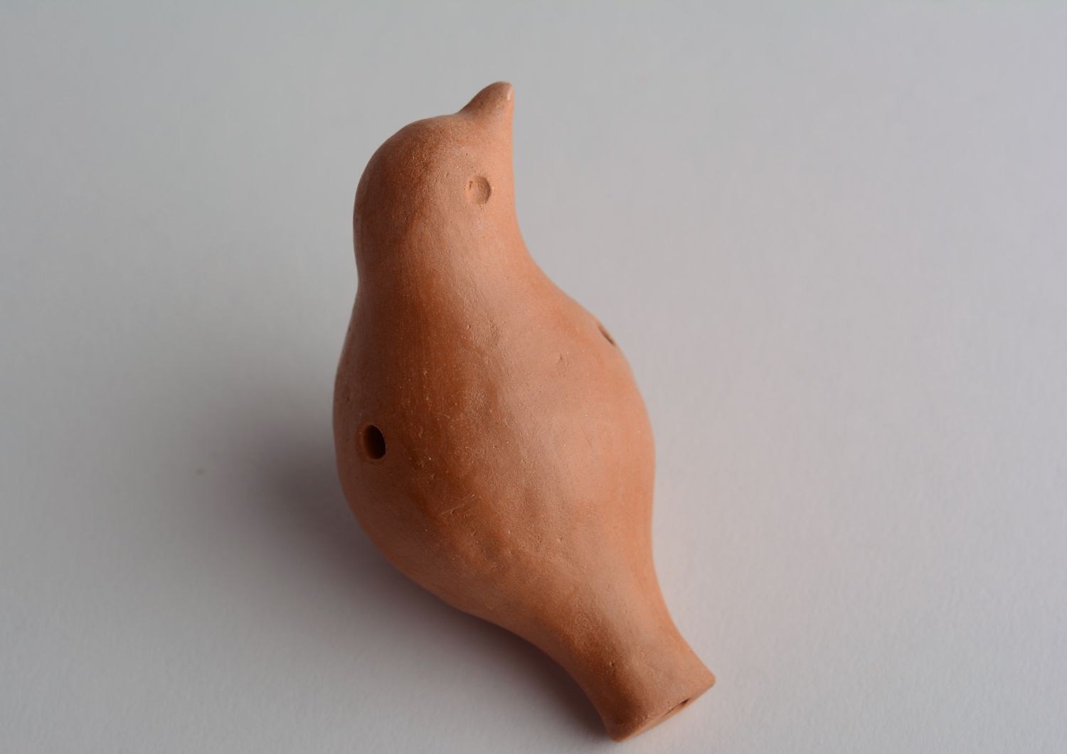 Clay penny whistle in the shape of a bird photo 2