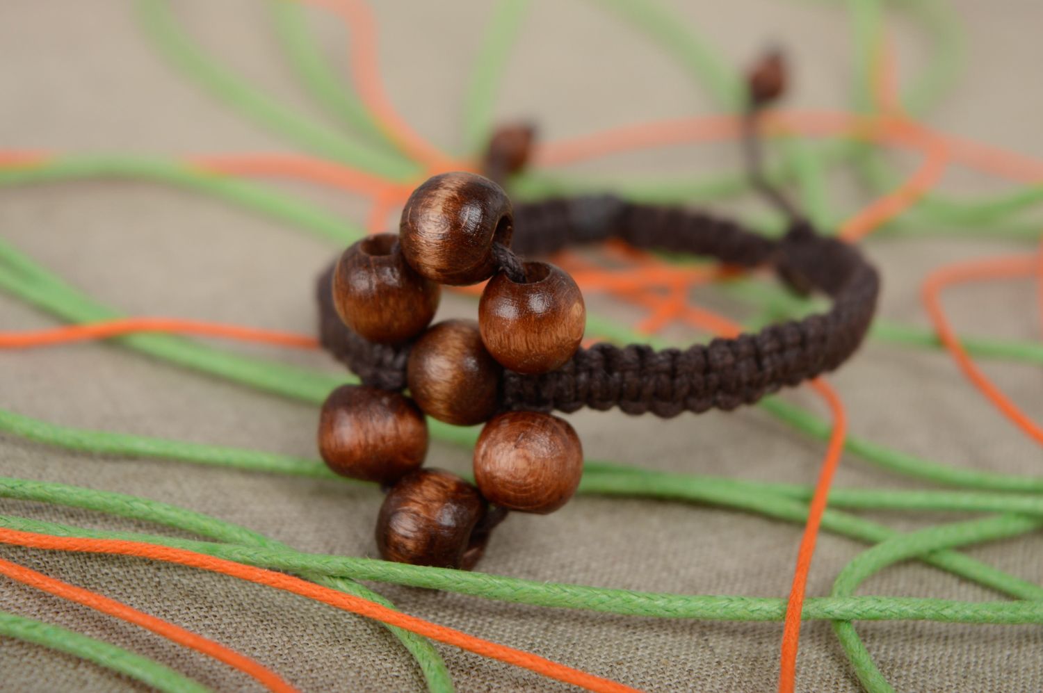Unusual macrame bracelet of brown color with wooden beads photo 2