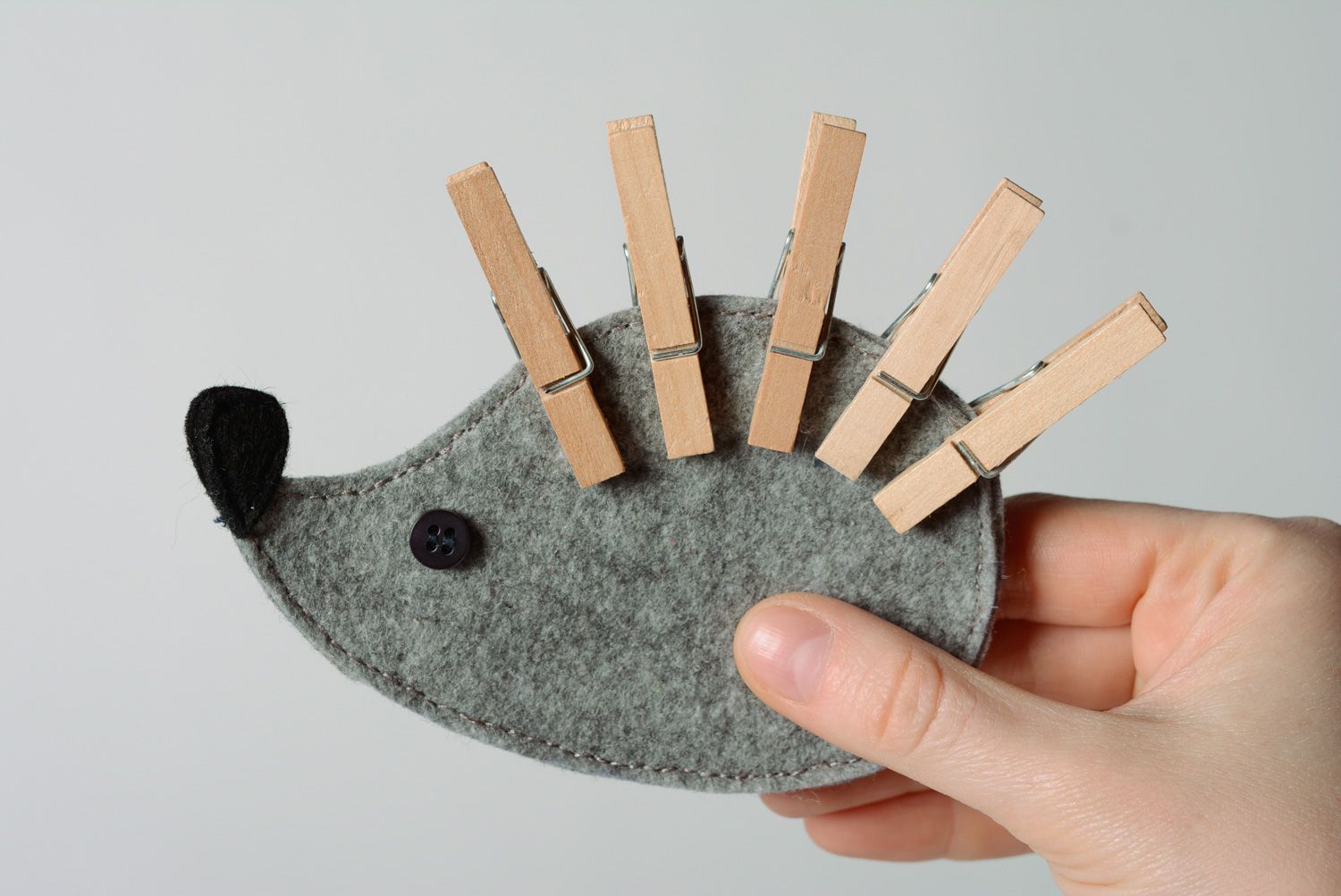 Handmade gray felt educational toy in the shape of hedgehog with clothes pins photo 1