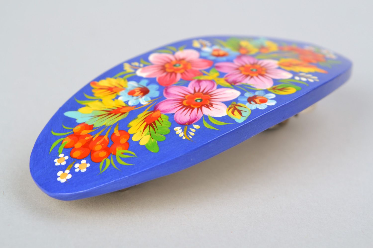 Handmade wooden oval hair clip with Petrikivka painting on blue background photo 4