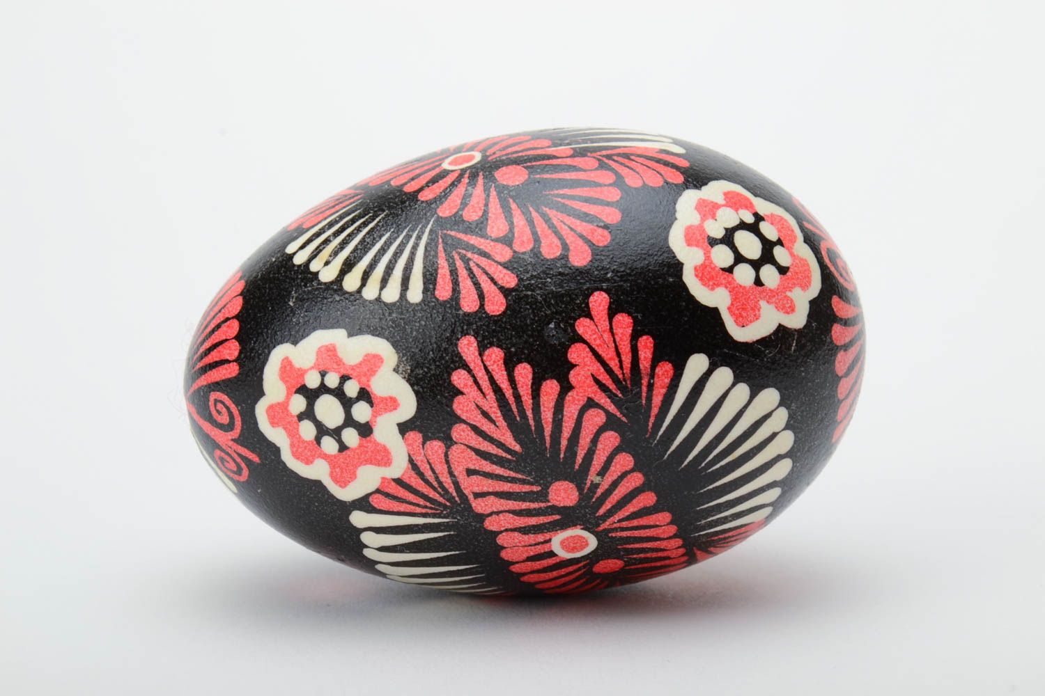 Handmade decorative painted Easter egg with ornament on black background photo 3