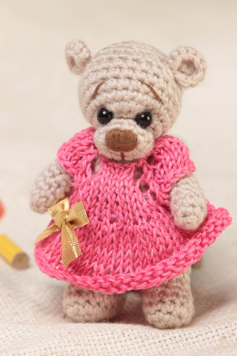 Small handmade beige soft toy bear in pink dress crocheted of acrylic threads  photo 1