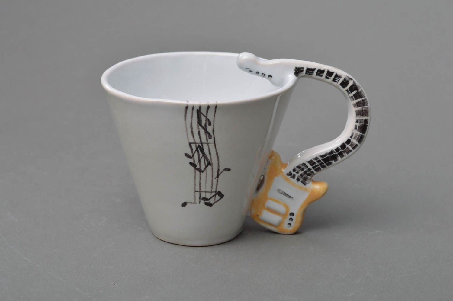 White porcelain coffee cup with handle in the shape of a guitar. Great gift for the musician or guitar man. photo 1
