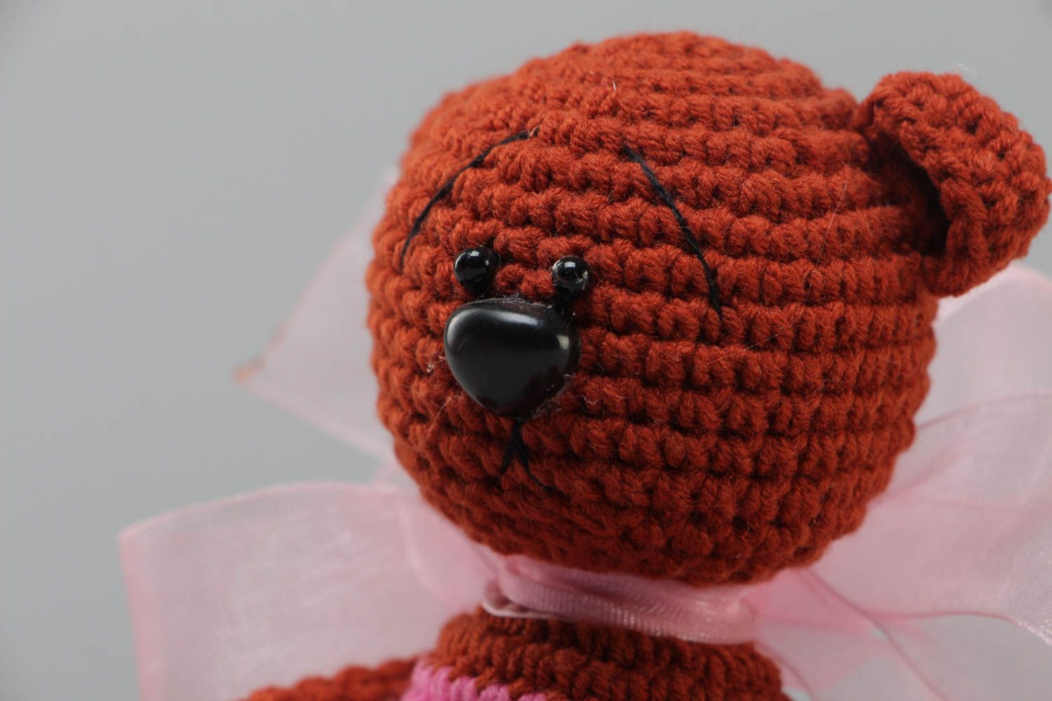 Handmade soft toy crocheted of acrylic threads brown bear with big pink bow photo 3
