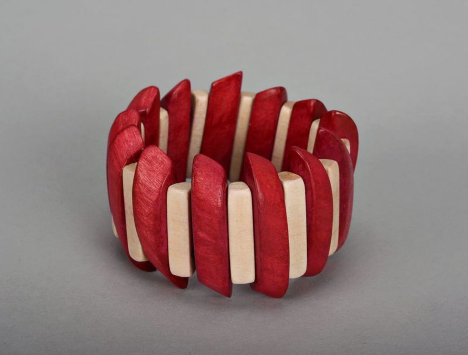 Wrist bracelet of red and white colors on elastic band photo 2