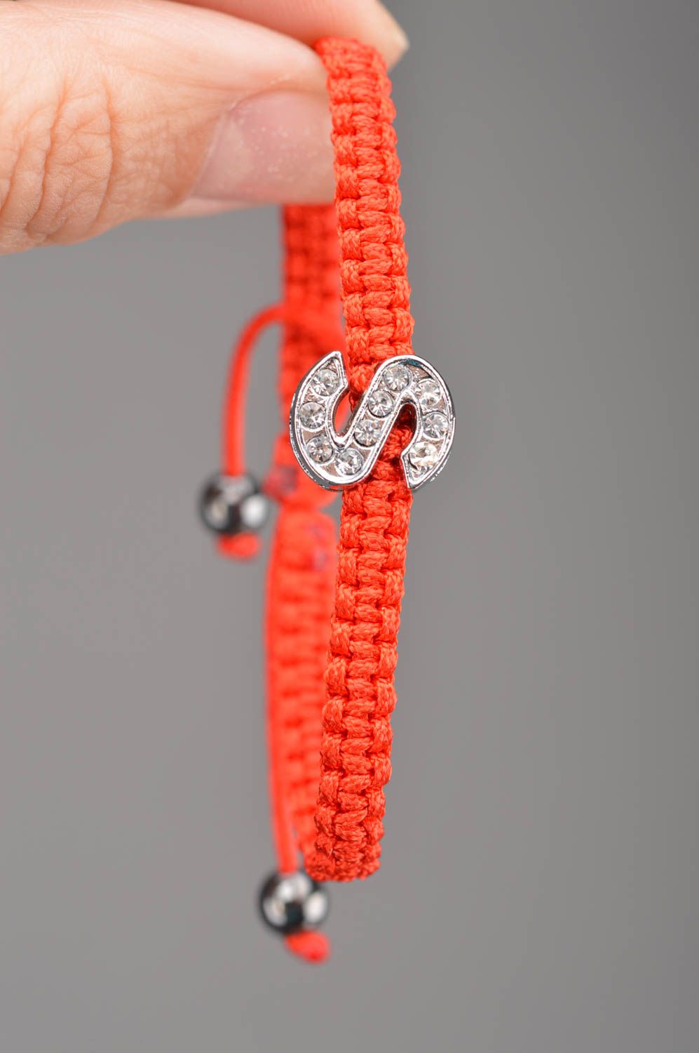 Lovely handmade women's friendship bracelet woven of red threads with letter S photo 2