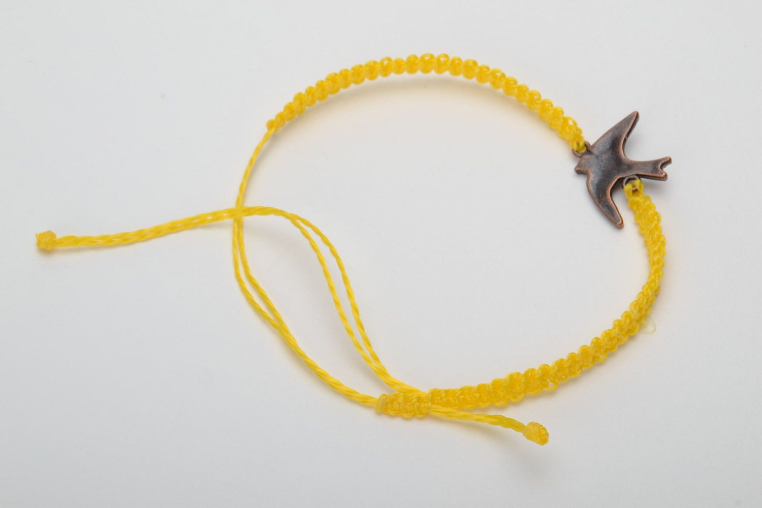 Handmade women's woven capron thread wrist bracelet of yellow color with metal bird charm photo 4