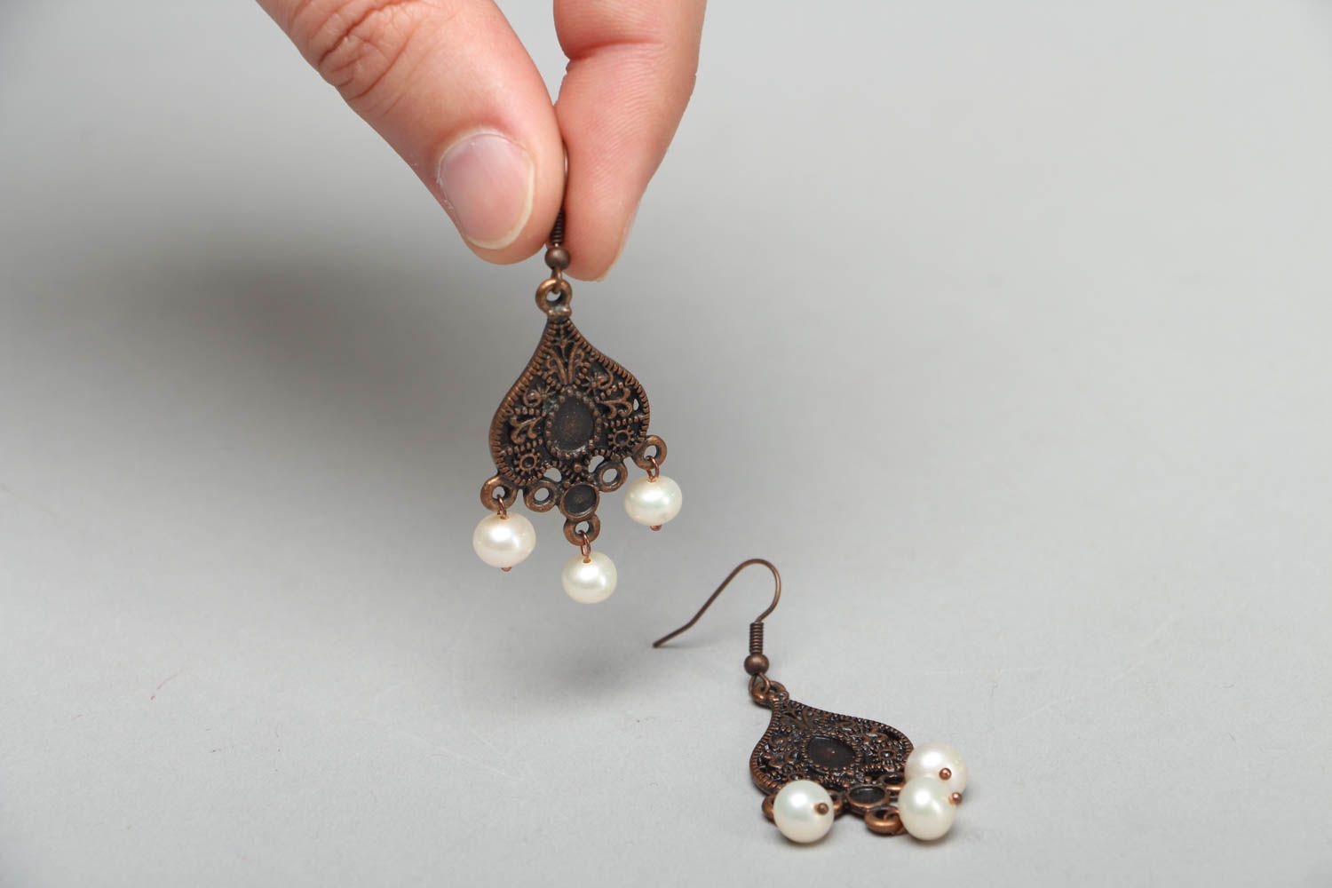 Metal earrings in Orient style with pearl-like beads photo 3