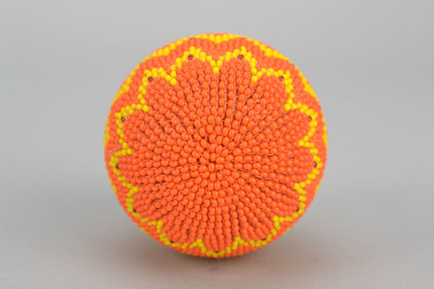 Wooden egg woven over with orange beads photo 5