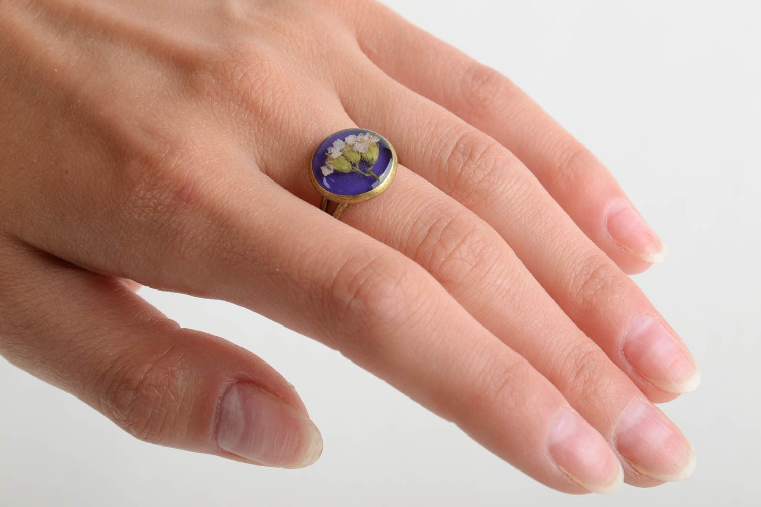 Small round handmade ring with dried flowers in epoxy resin on metal basis photo 2