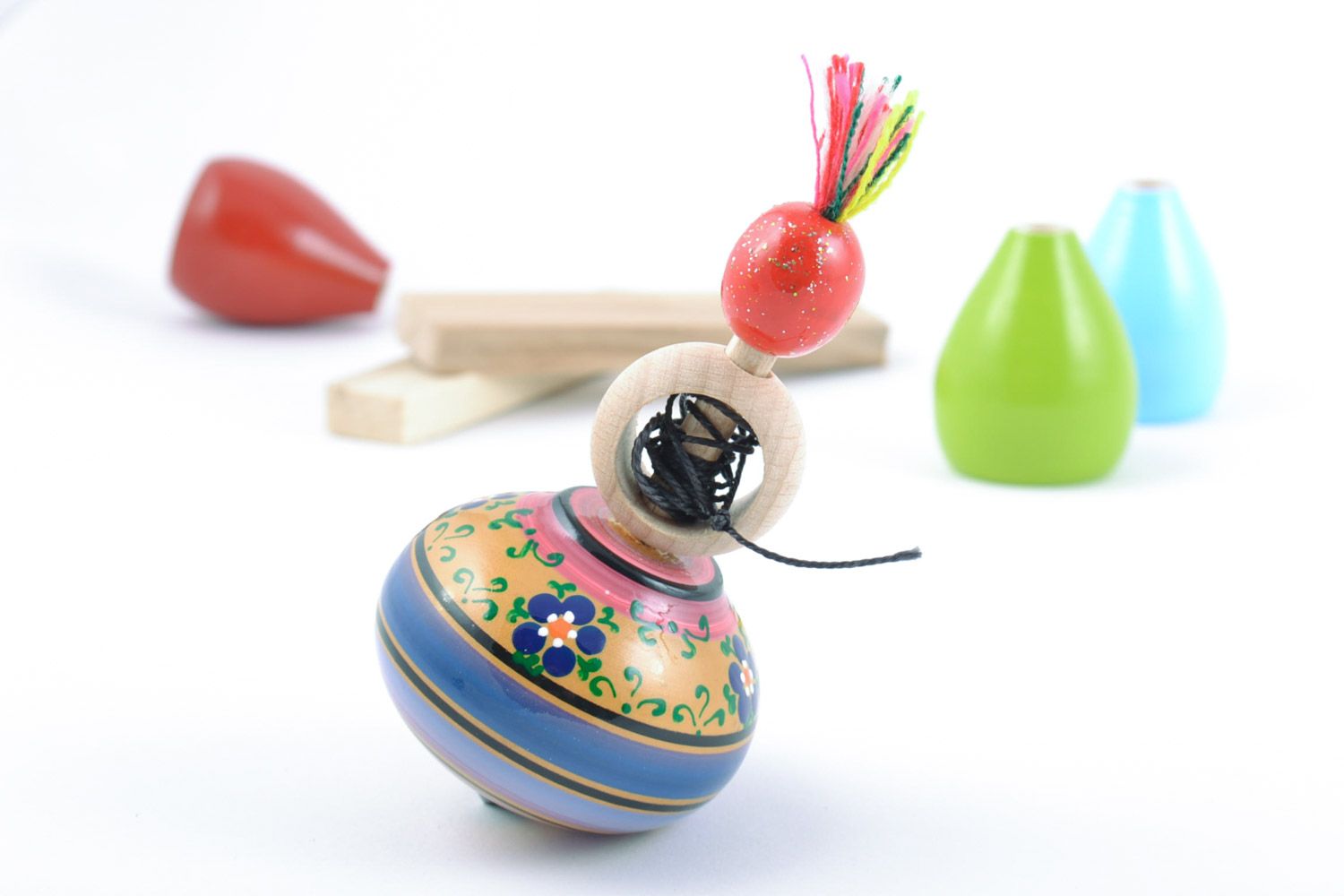 Handmade painted wooden spinning top toy for fine motor skills development photo 1