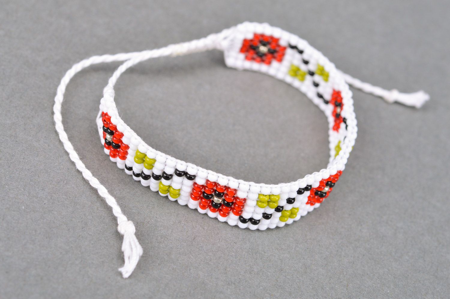 Handmade ethnic wrist bracelet woven of beads in white and red colors for women photo 2