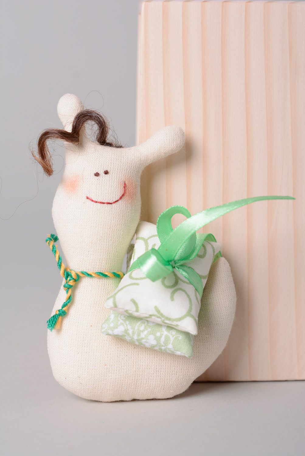 Handmade soft toy sewn of natural fabrics in the shape of small funny snail  photo 1