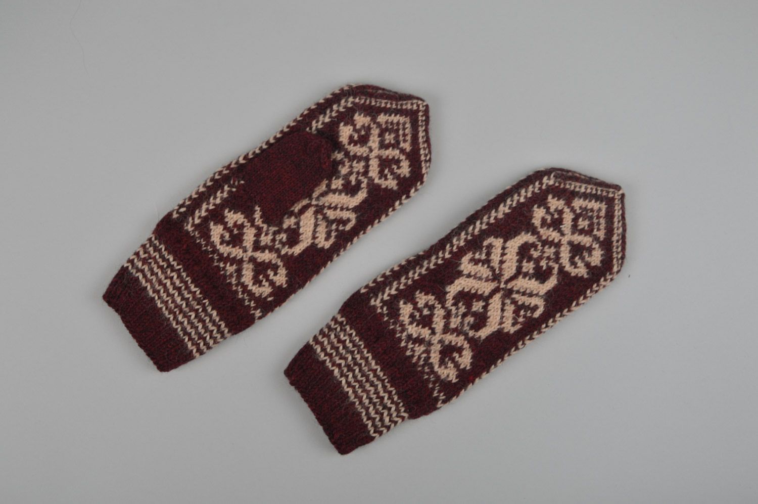 Homemade warm winter knit woolen mittens with ornaments in brown color palette photo 4