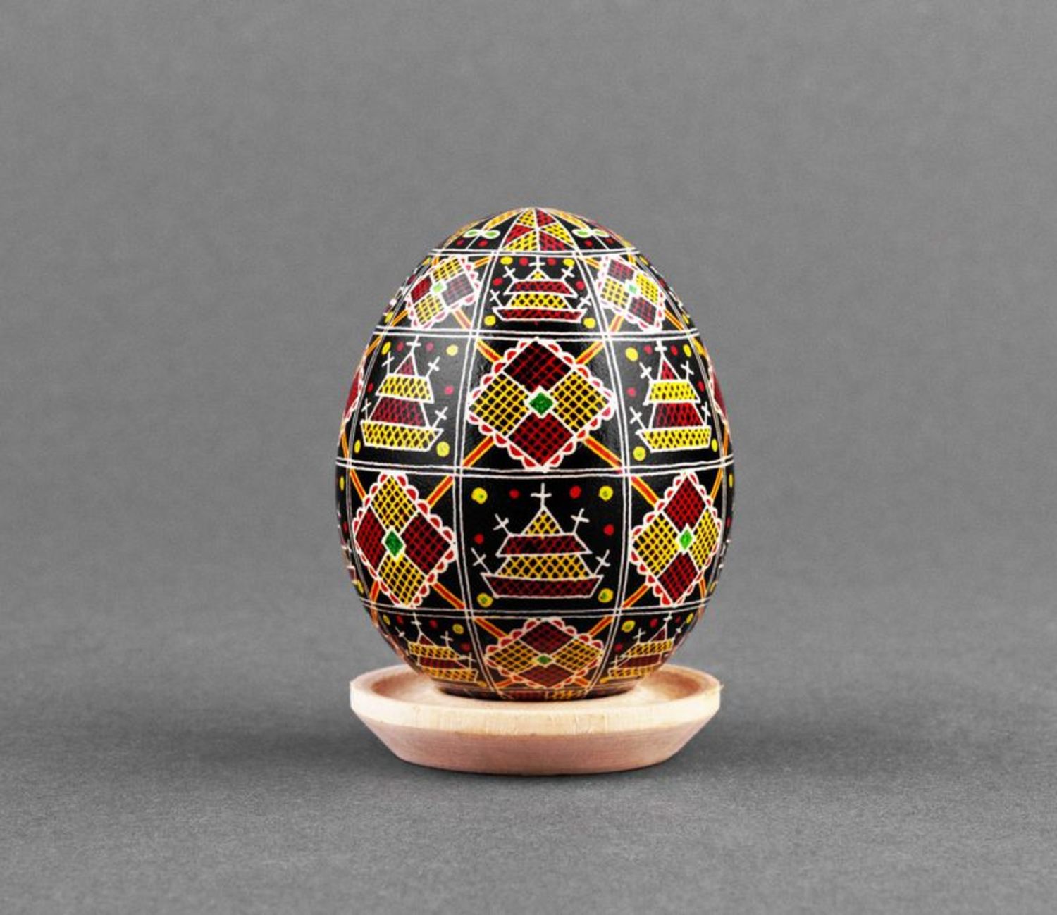 Black pysanka with red and yellow ornament photo 3