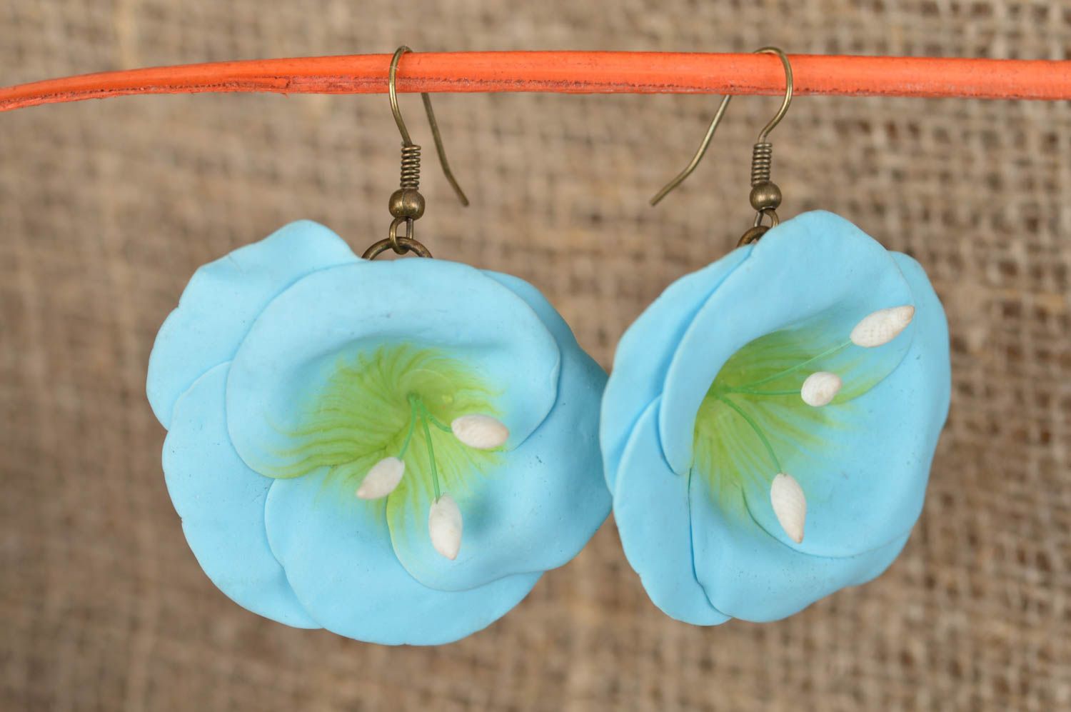 Handmade female earrings made of polymer clay in shape of blue flowers photo 1
