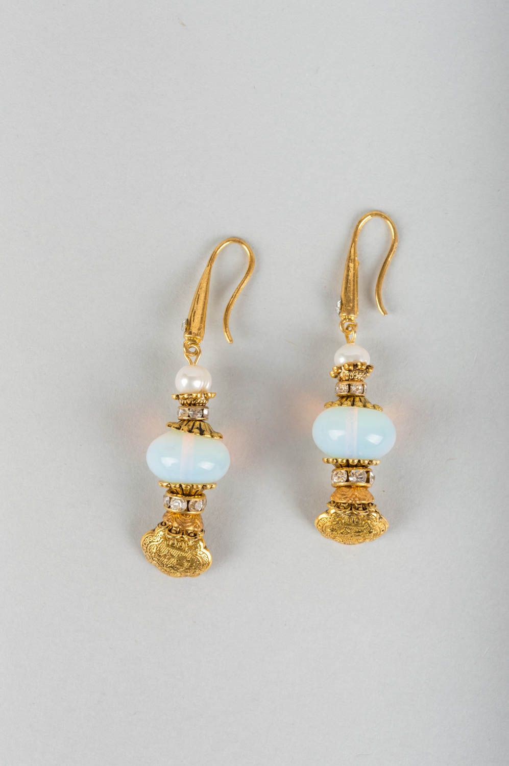Beautiful female earrings with charms made of metal with pearls and moonstone photo 2