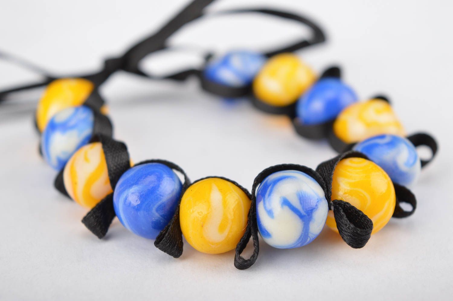 Stylish handmade yellow and blue beads bracelet on a black textile cord for her photo 2
