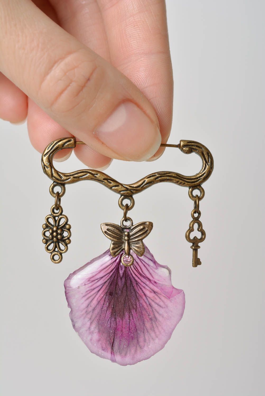 Handmade designer metal figured pin brooch with violet petal in epoxy resin photo 2