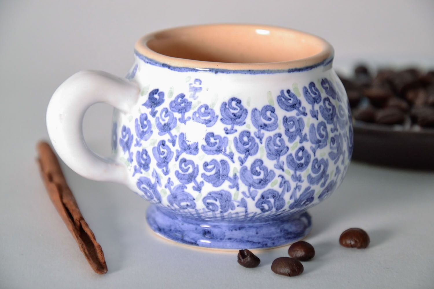 Handmade clay glazed drinking cup in white and blue color with violets' pattern photo 1