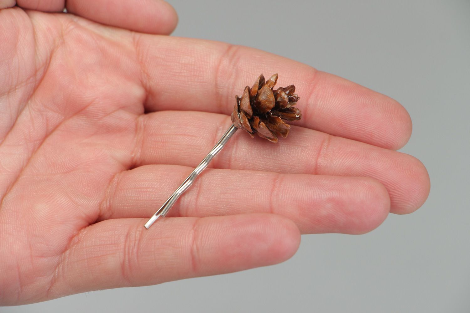 Handmade small metal hair pin with natural cone coated with epoxy resin  photo 3